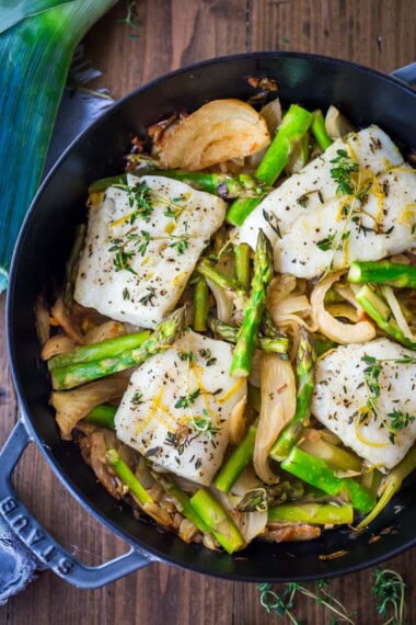Here's one of my favorite cod recipes, perfect for spring! This lemony cod is baked with asparagus, fennel, and leeks, seasoned with olive oil, garlic, fresh thyme, and lemon.