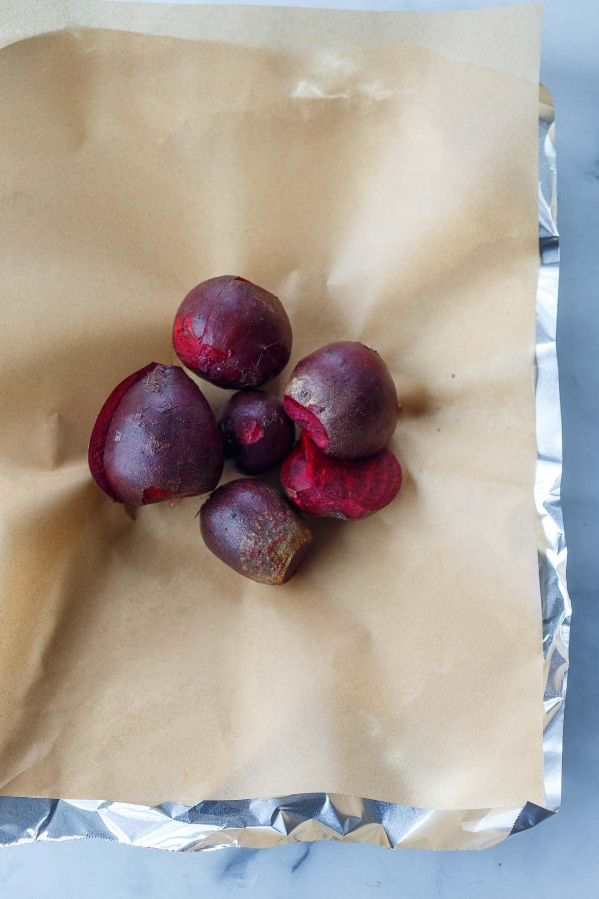beets on a layer of parchment on top of a layer of foil.