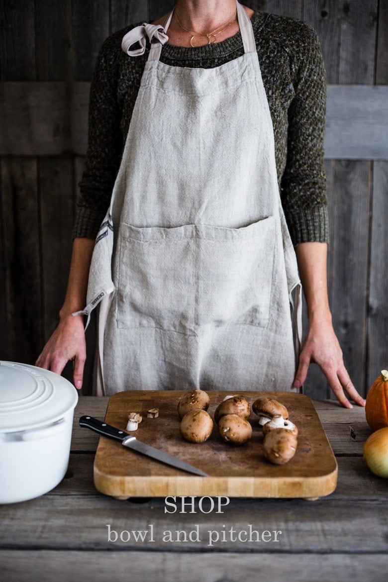 Jill Murdoch wearing a natural linen apron form Bowls and Pitcher store