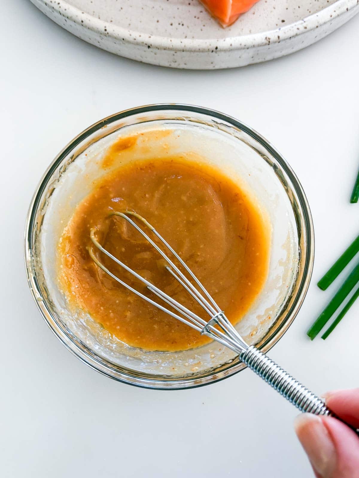 small bowl of miso paste glaze with a silver whisk to stir.