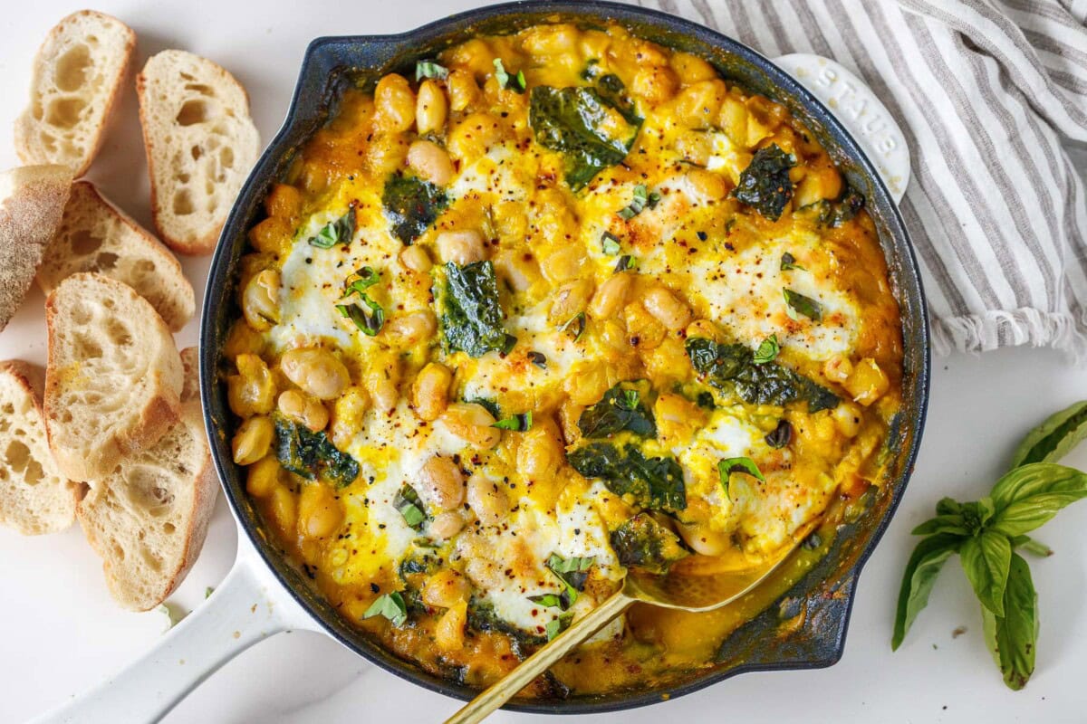 This fall-inspired recipe for baked beans with creamy butternut sauce, kale, basil, and burrata cheese is so cozy!  A delicious vegetarian meal perfect for fall!