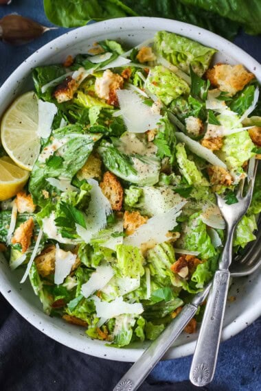 How to make a classic Caesar salad with a creamy tangy dressing, parmesan cheese and homemade croutons.