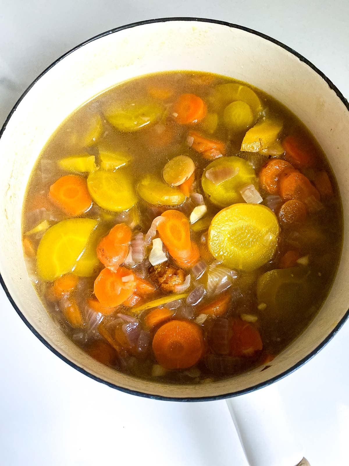 cooked carrots, ginger, and onion in a sauce pan.