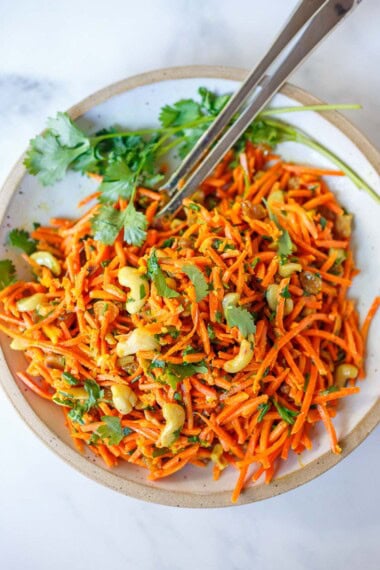 Fresh and flavorful, this carrot salad recipe is infused with Indian flavor! Studded with toasted cashews and raisins, fresh grated carrots are tossed in a delicious Indian curry dressing. Easy, healthy, vegan, and perfect for gatherings!