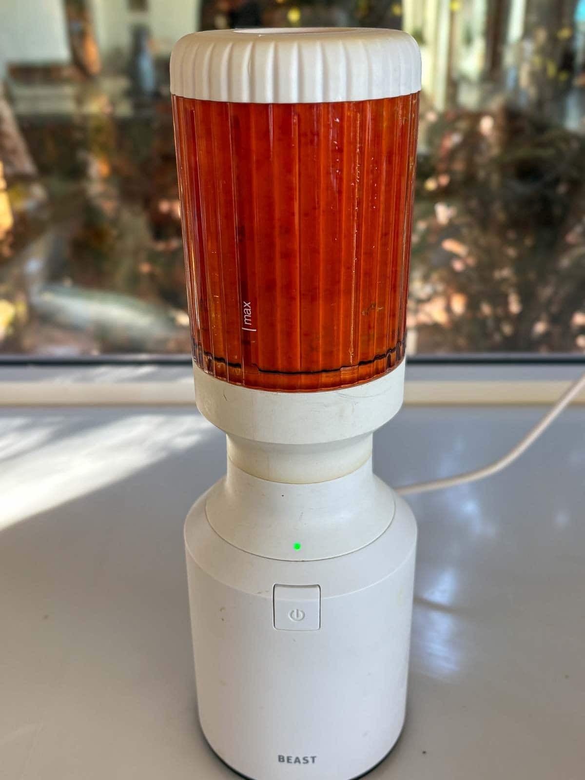 small white beast blender blending chili garlic sauce.