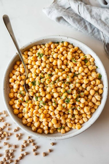 Learn how to cook dried chickpeas from scratch! We'll show you how to soak them and cook them 3 ways: on the stovetop, in the Instant Pot (our favorite), or in a slow cooker. Batch-cook them ahead, for delicious, nutritious meals.