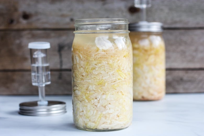 How to make Simple Cultured Cabbage!  Aka Sauerkraut- a delicious tangy addition to many dishes. Brimming with gut-healing probiotics, fermented cabbage is easy to make at home with just two ingredients!  