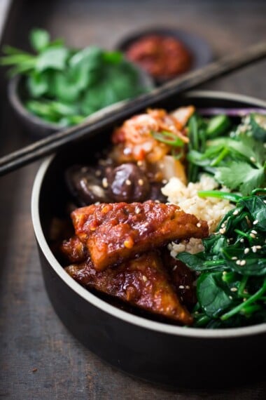 This Bibimbap recipe (aka Seoul Bowl) is made with gochujang-baked Tempeh, steamed veggies, kimchi and quick pickled cucumbers- a healthy vegan version of Bibimbap! 