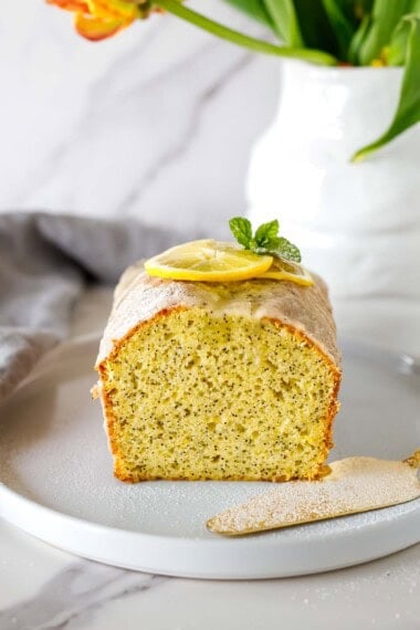 Bright and tangy, this easy lemon poppy seed cake is moist and light! Lemon zest gives it an extra burst of lemon flavor, with a hint of warmth from vanilla. Drizzle with our easy lemon glaze.