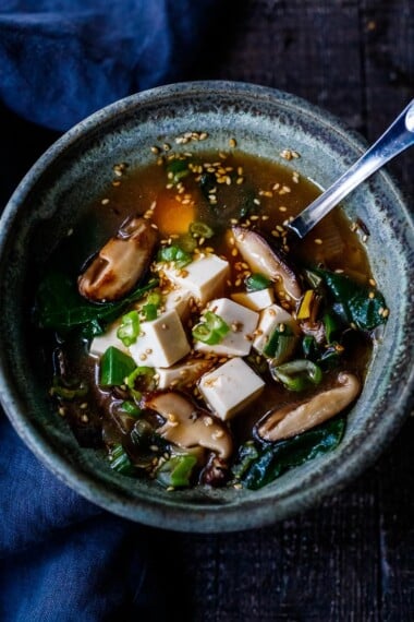 20-minute Miso Soup Recipe with leeks, shiitake mushrooms, wilted greens, and tofu makes for a fast and easy weeknight dinner. Full of flavor and nutrients it is highly nourishing while remaining light and lean. Vegan and GF adaptable.
