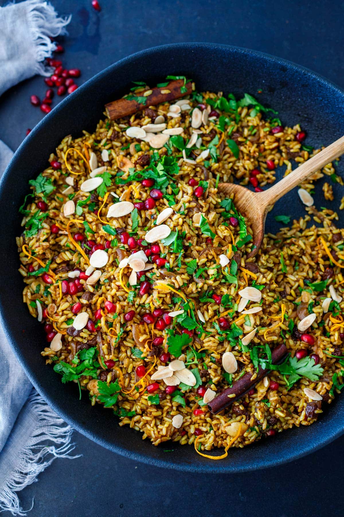 large skillet with Moroccan rice with herbs, almonds, pomegranate seeds, and lemon zest. 