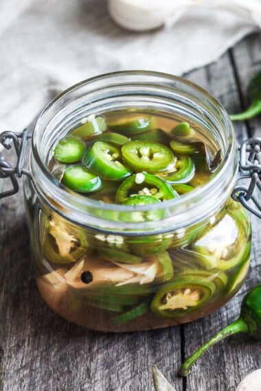 Pickled jalapeno peppers are easy to make in 15 minutes! They add a happy burst of flavor to tacos, burritos, nachos, quesadillas, sandwiches, burgers,  salads, soups, and more.  The uses are truly endless!