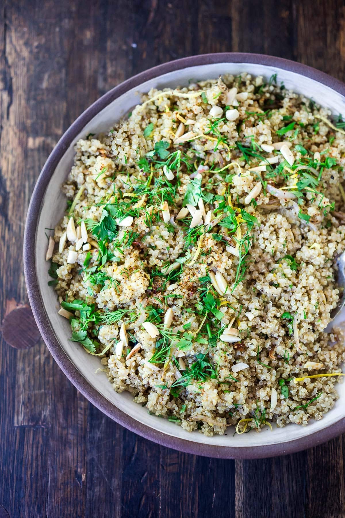bowl of herbed quinoa with lemon zest and slivered almonds. 