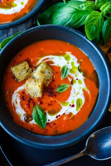 This roasted red pepper and tomato soup recipe is healthy and delicious! Made with fresh summer tomatoes and peppers, garlic and basil. Vegan.