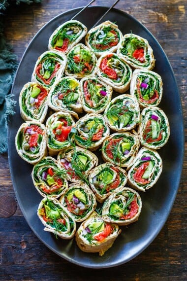 These lavash wraps are filled with smoked salmon, fresh dill, capers, red onion, avocado, arugula, whipped cream cheese and lemon zest. An easy, 15-minute appetizer or quick healthy lunch!