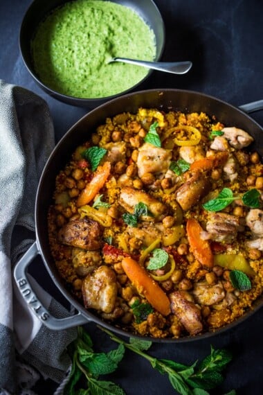 A delicious Tunisian-inspired Chicken Tagine (or sub chickpeas) with couscous, carrots, and flavorful Green Harissa Sauce. A one-pan meal that can be made in 45 minutes! Vegan and Gluten-free adaptable!&nbsp;