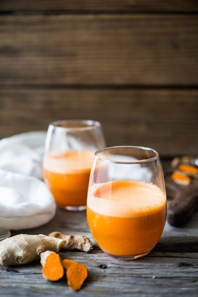 Fresh carrot juice with turmeric and ginger in a glass. 