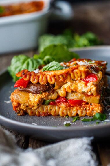 The best Veggie Lasagna recipe! This homemade vegetarian lasagna is layered with savory roasted vegetables, marinara sauce, ricotta, and creamy goat cheese- a cozy vegetarian dinner perfect for feeding a crowd.