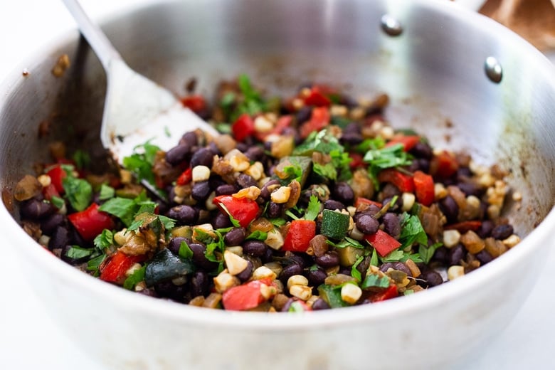 enchilada filling with cilantro in a skillet.
