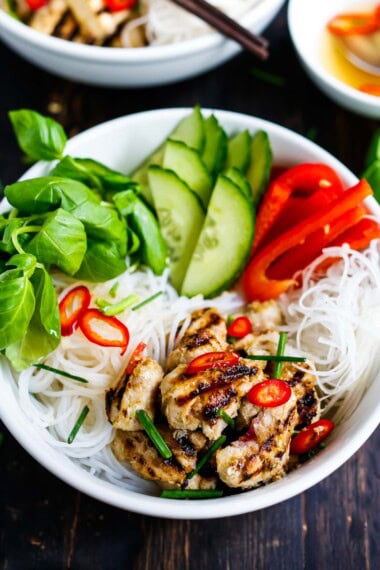 A healthy Vietnamese Vermicelli Noodle Bowl with your choice of lemongrass chicken, shrimp, or tofu served over vermicelli rice noodles, fresh veggies, basil, and a flavorful Vietnamese dressing called Nuoc Cham.